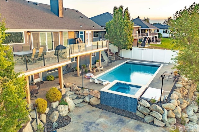 view of pool with a fenced in pool, a patio, an in ground hot tub, a fenced backyard, and stairs