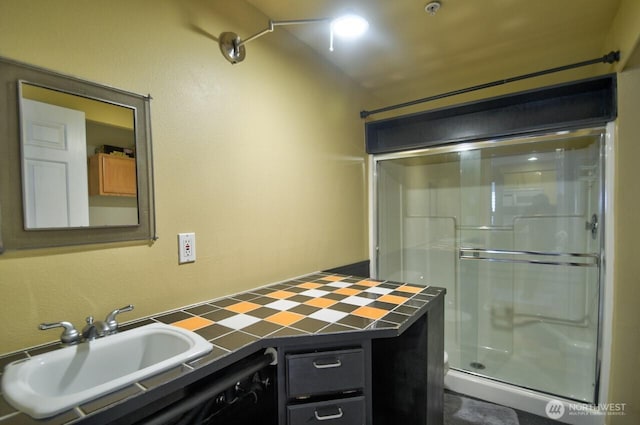 full bathroom featuring a stall shower and a sink