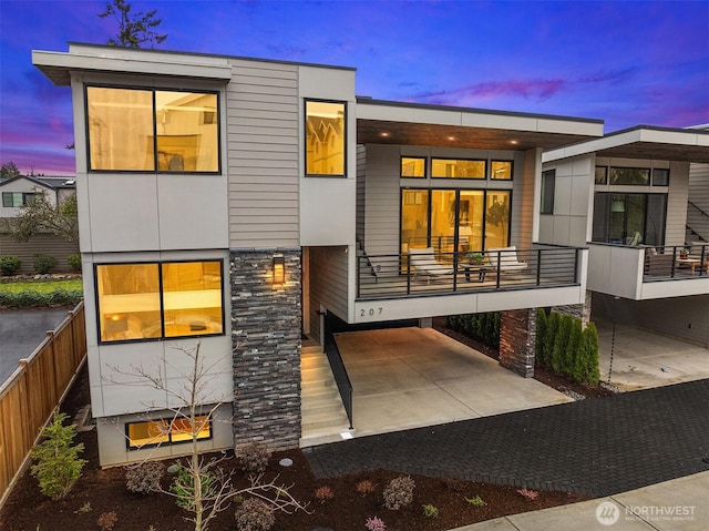 back of property at dusk with a porch