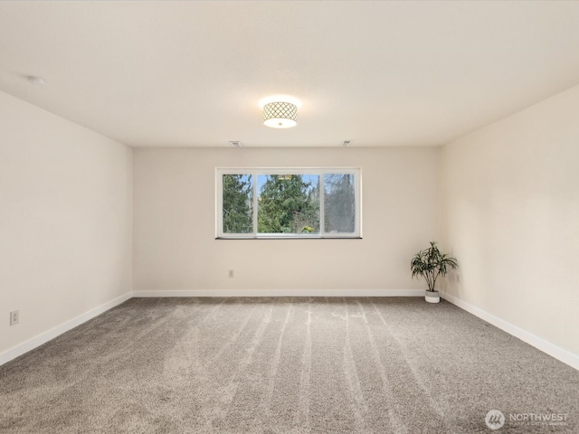 carpeted empty room with baseboards