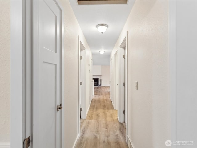 corridor with light wood finished floors