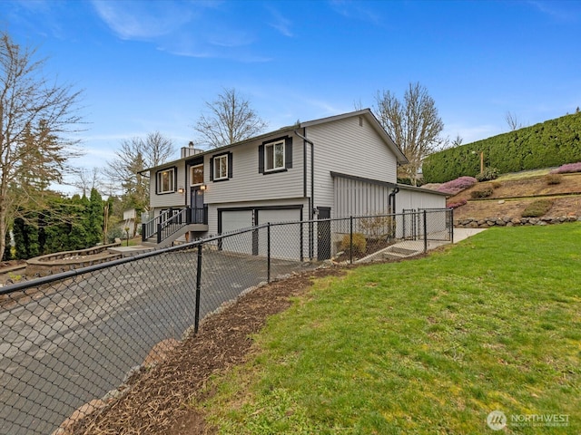 view of side of home featuring a yard, fence, an attached garage, and aphalt driveway