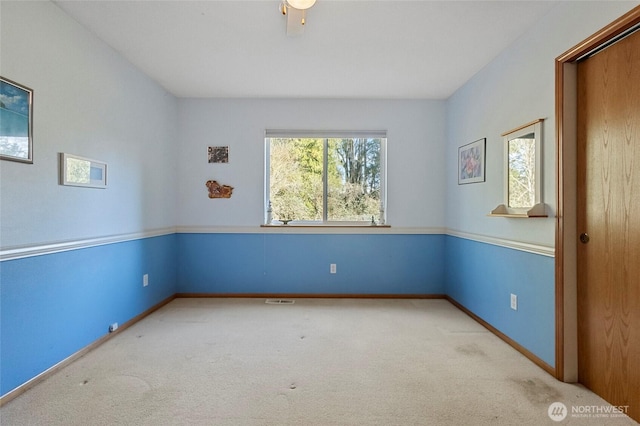 unfurnished room with baseboards and carpet floors