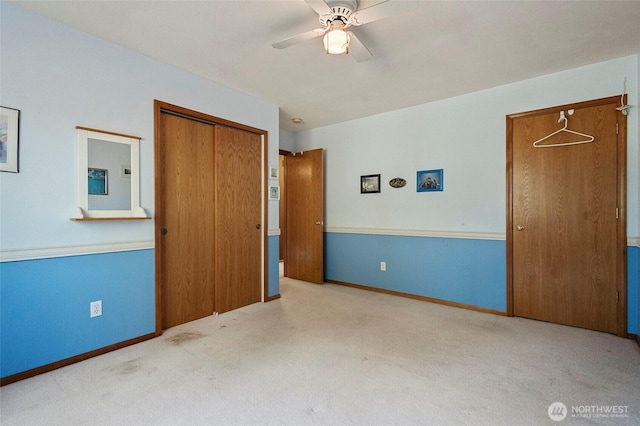 unfurnished bedroom with a closet, baseboards, and carpet floors