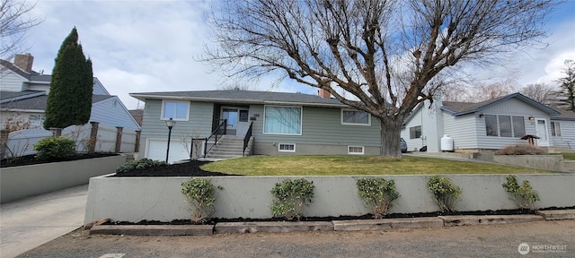 view of front of home with a fenced front yard, a chimney, concrete driveway, a front yard, and a garage