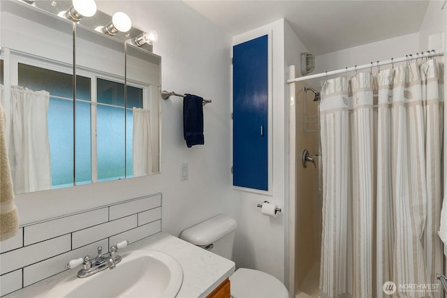 full bath featuring vanity, a shower with shower curtain, toilet, and tasteful backsplash