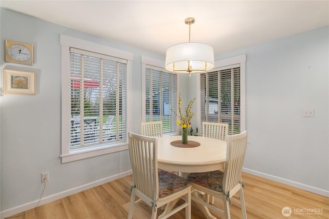 dining room with baseboards and wood finished floors