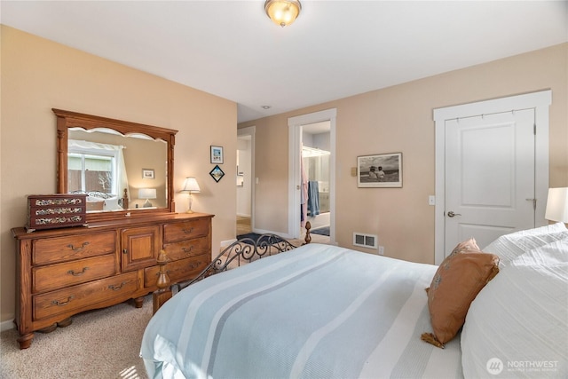 bedroom featuring visible vents and light colored carpet