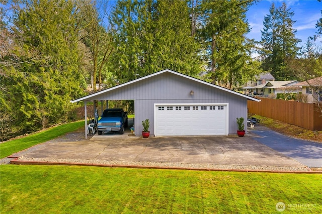 garage featuring a garage and fence