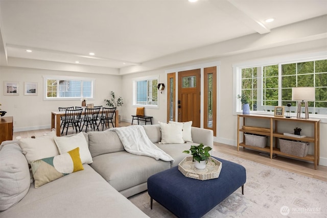 living area with light wood-style flooring, plenty of natural light, and recessed lighting