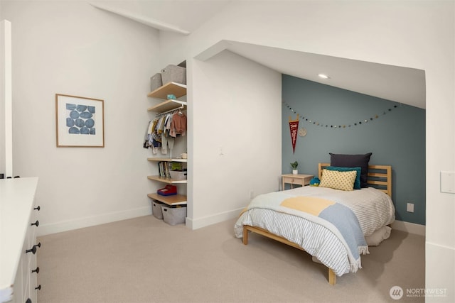 carpeted bedroom featuring vaulted ceiling and baseboards