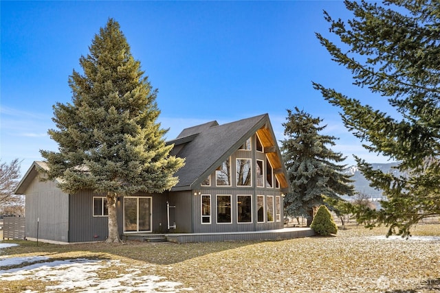 back of property featuring roof with shingles