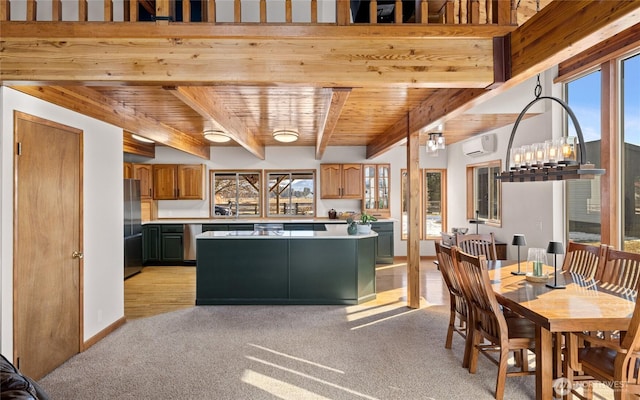 kitchen featuring wooden ceiling, freestanding refrigerator, a wall mounted air conditioner, light countertops, and beam ceiling