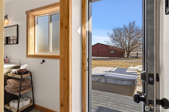 doorway to outside with a wealth of natural light and baseboards