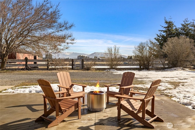 view of patio / terrace featuring a fire pit and fence