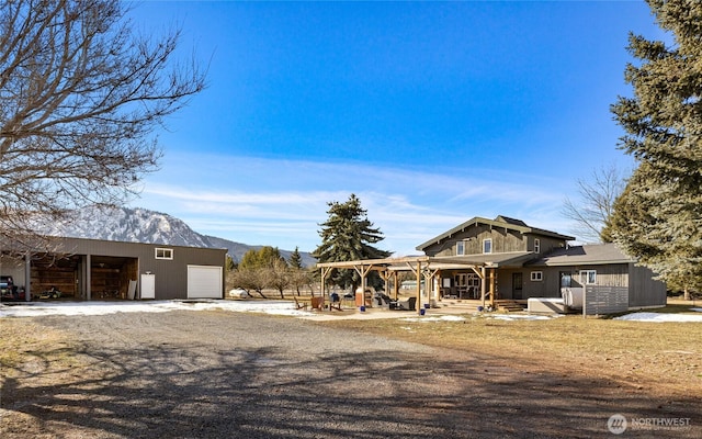 view of front of home featuring driveway and a mountain view