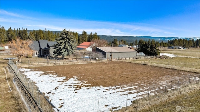 view of yard with fence, a mountain view, and a rural view