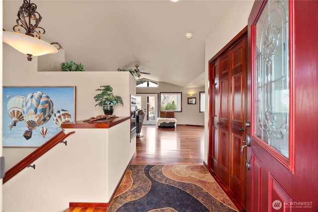 entryway featuring lofted ceiling, ceiling fan, baseboards, and wood finished floors