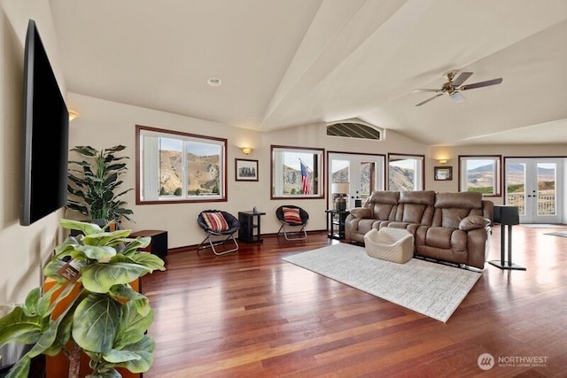 living area featuring a ceiling fan, lofted ceiling, french doors, and wood finished floors