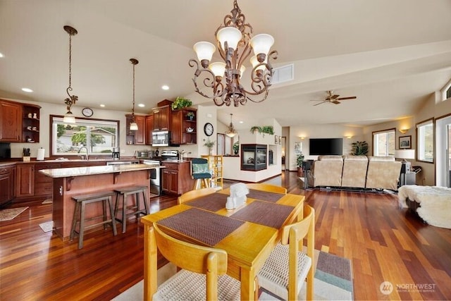 dining room with dark wood-style flooring, recessed lighting, visible vents, a ceiling fan, and vaulted ceiling