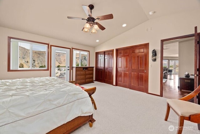 carpeted bedroom with a ceiling fan, lofted ceiling, access to exterior, two closets, and recessed lighting