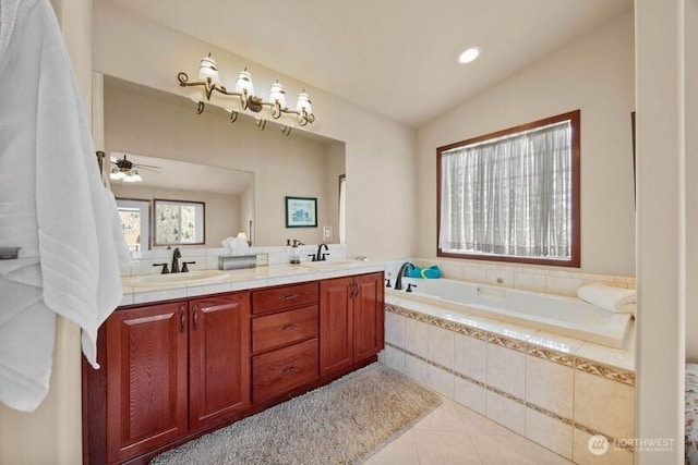 bathroom featuring a garden tub, double vanity, lofted ceiling, a sink, and tile patterned flooring