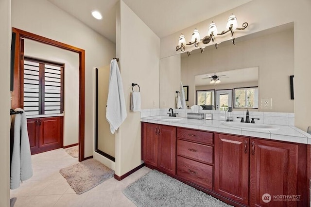 bathroom featuring tile patterned floors, a sink, a shower stall, and double vanity