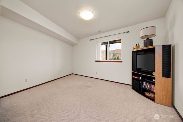 interior space with carpet and baseboards