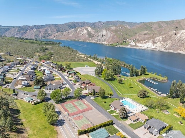 drone / aerial view with a water and mountain view