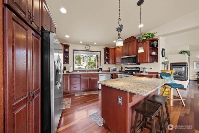 kitchen featuring appliances with stainless steel finishes, dark wood finished floors, a sink, and open shelves