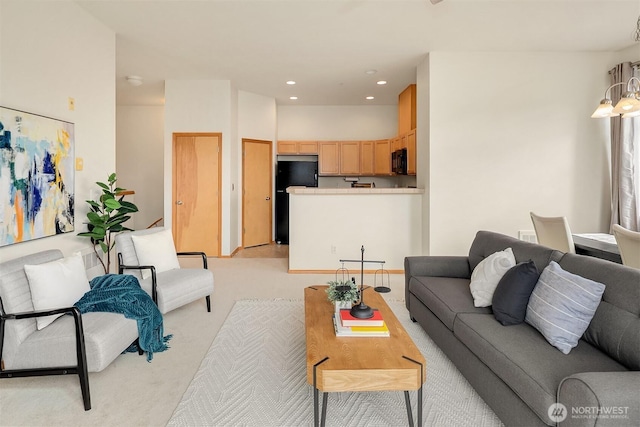 living room with recessed lighting and light colored carpet