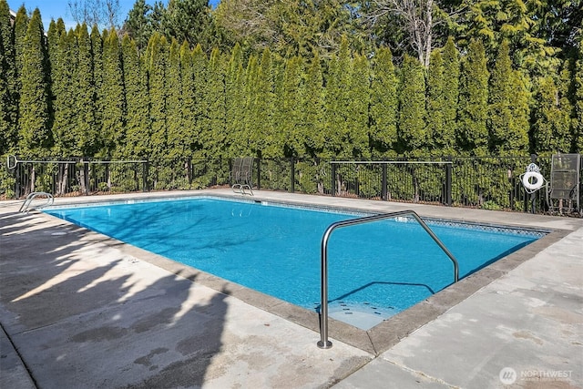 view of pool with a fenced in pool, a patio, and fence