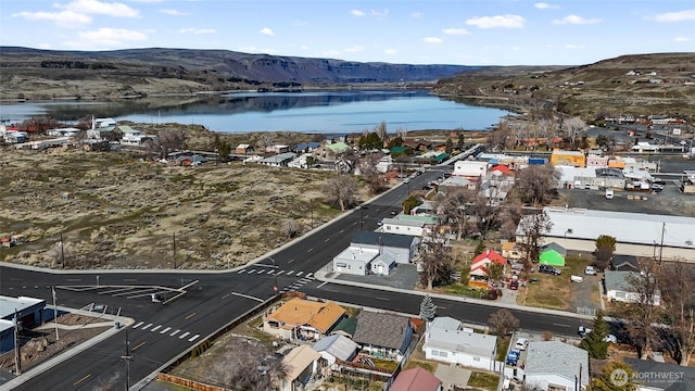 birds eye view of property with a water and mountain view