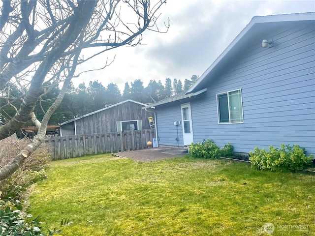 rear view of property with a patio area, fence, and a yard