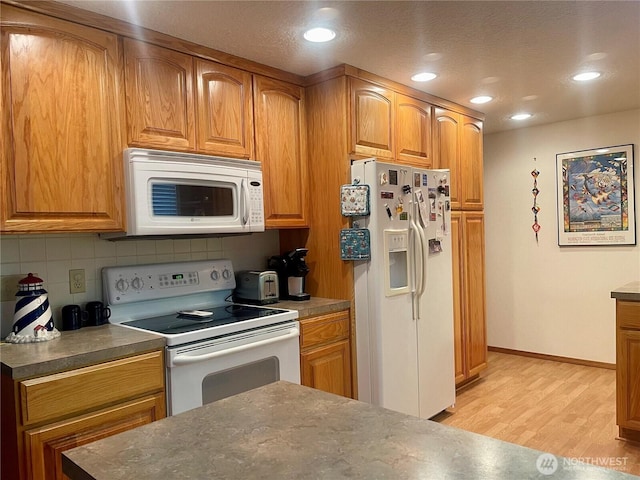 kitchen featuring light wood finished floors, white appliances, backsplash, and brown cabinets