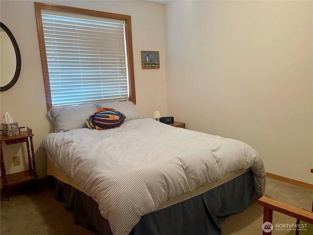 carpeted bedroom featuring baseboards