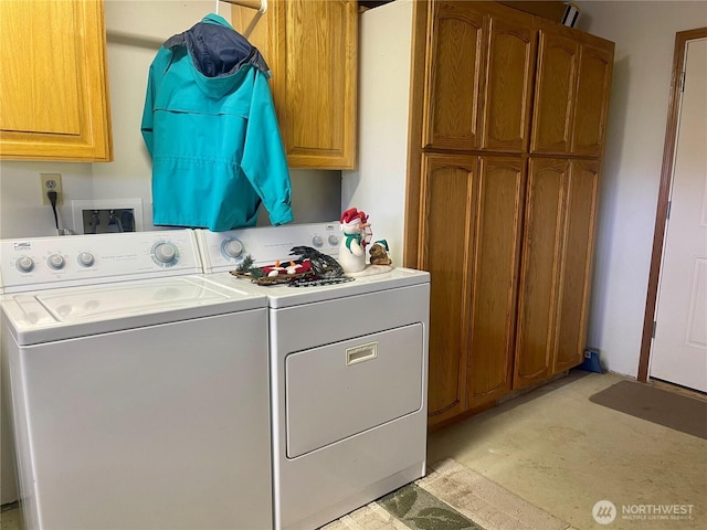 washroom with cabinet space and separate washer and dryer