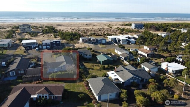 drone / aerial view featuring a water view and a view of the beach