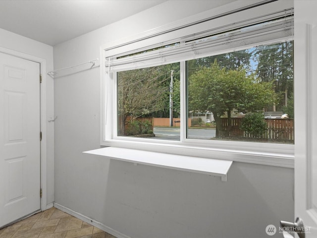 doorway featuring baseboards