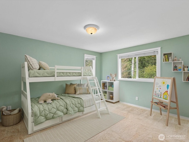 carpeted bedroom featuring baseboards