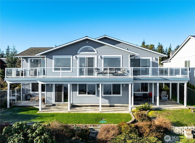 rear view of house featuring entry steps, a patio, and a balcony