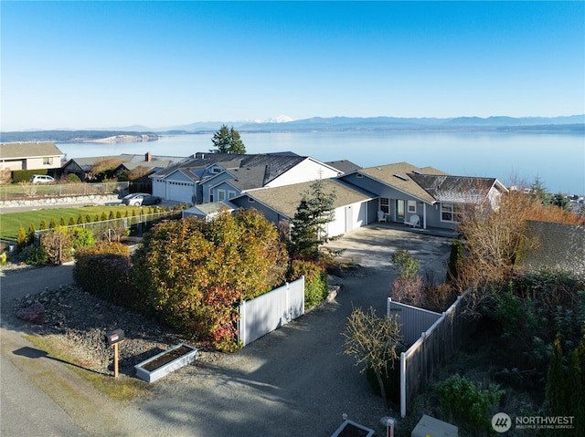 drone / aerial view with a residential view and a water and mountain view