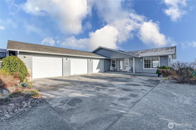 ranch-style home with an attached garage and driveway