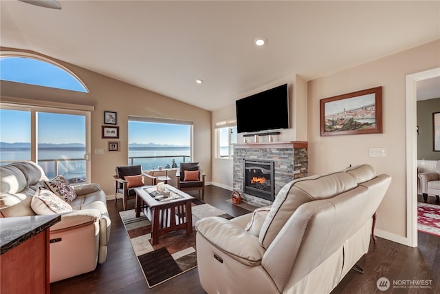 living area with dark wood-style flooring, a fireplace, vaulted ceiling, and baseboards