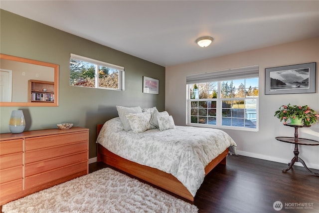 bedroom featuring dark wood-style floors and baseboards