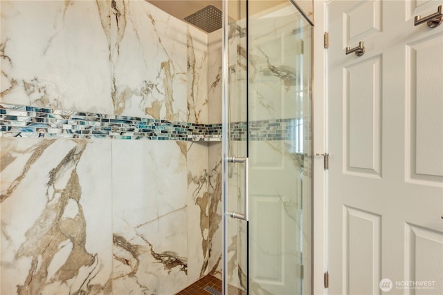 bathroom with a marble finish shower