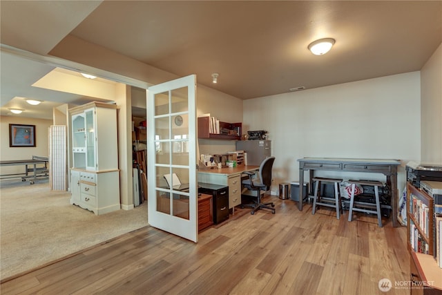 office area featuring light wood-type flooring, french doors, and visible vents