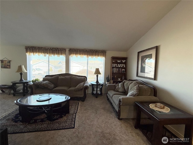 living area with lofted ceiling and light carpet