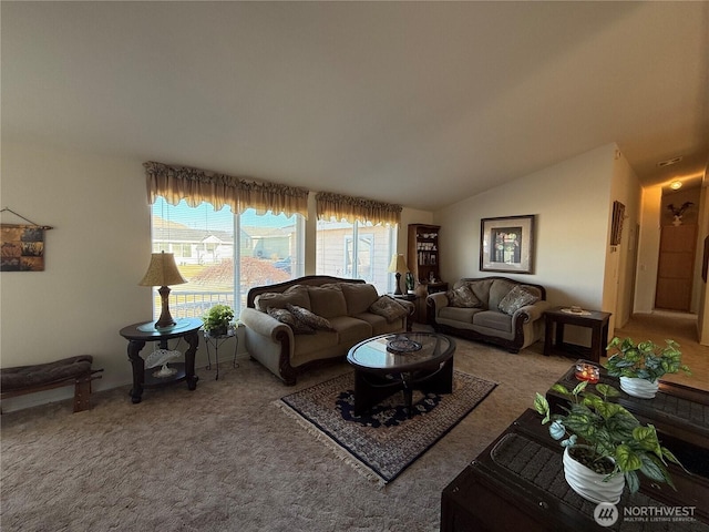 living area featuring carpet floors and vaulted ceiling