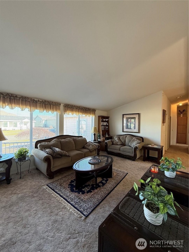 living area featuring carpet floors and lofted ceiling